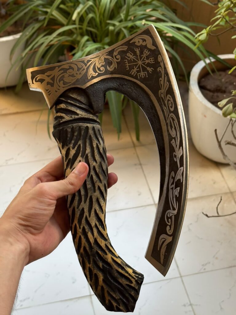 Engraved Viking axe with a carved wooden handle