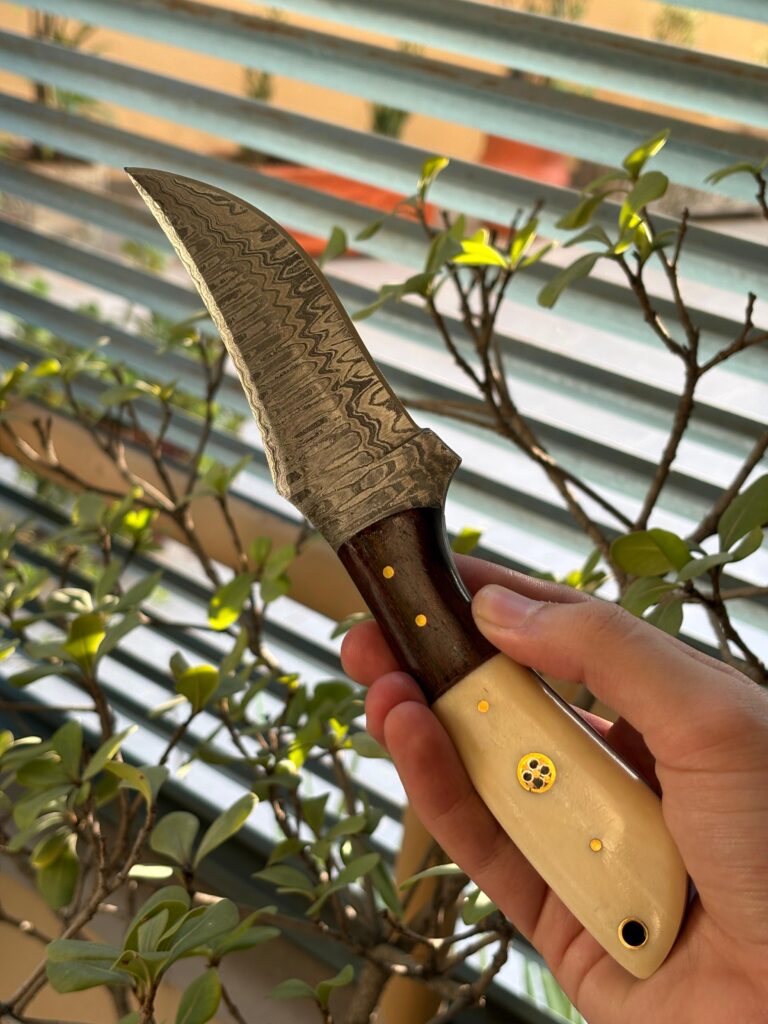 Damascus steel knife with a two tone handle